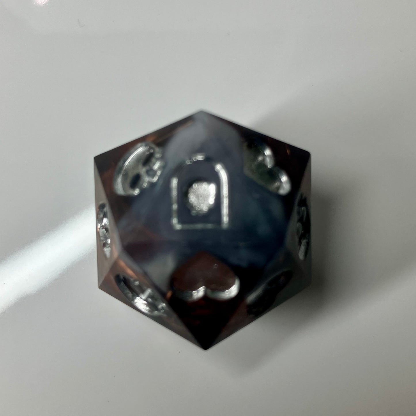 Copper, marble and silver come together in this hand made d20