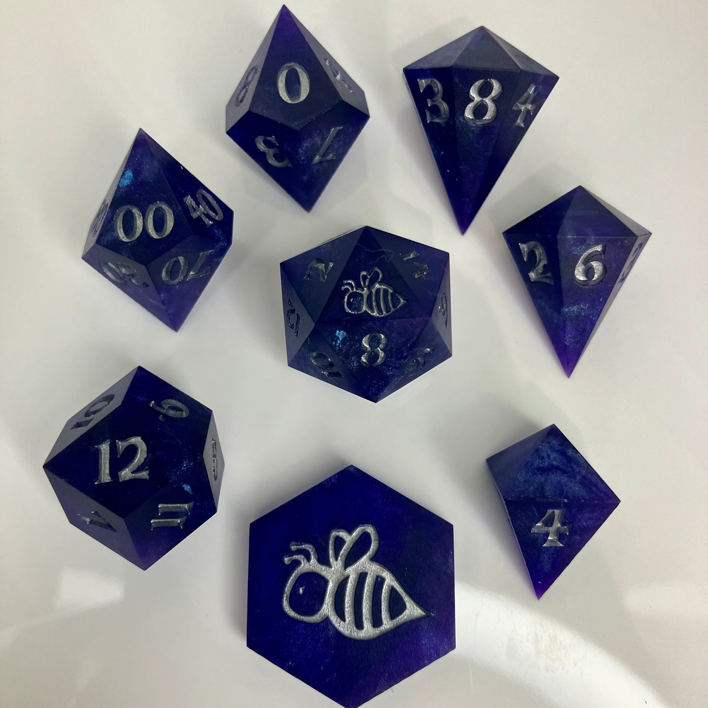 royal purple dice with numbers painted silver in gemstone shapes
