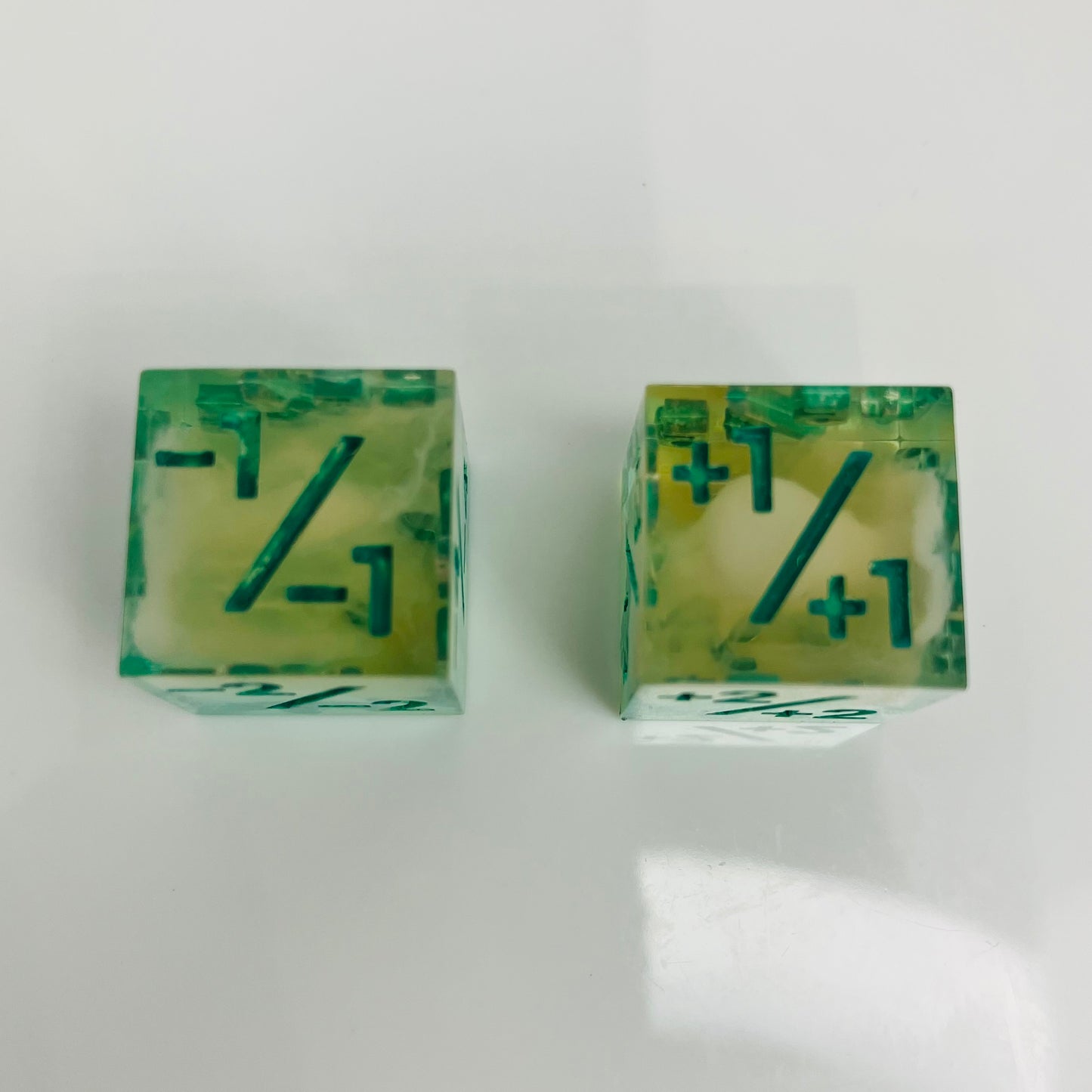 Green and yellow transparent dice with spore cloud inside.