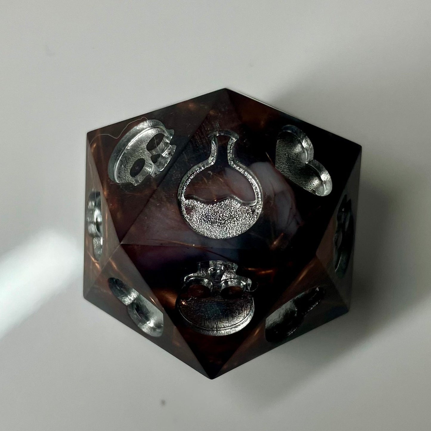 Copper, marble and silver come together in this hand made d20