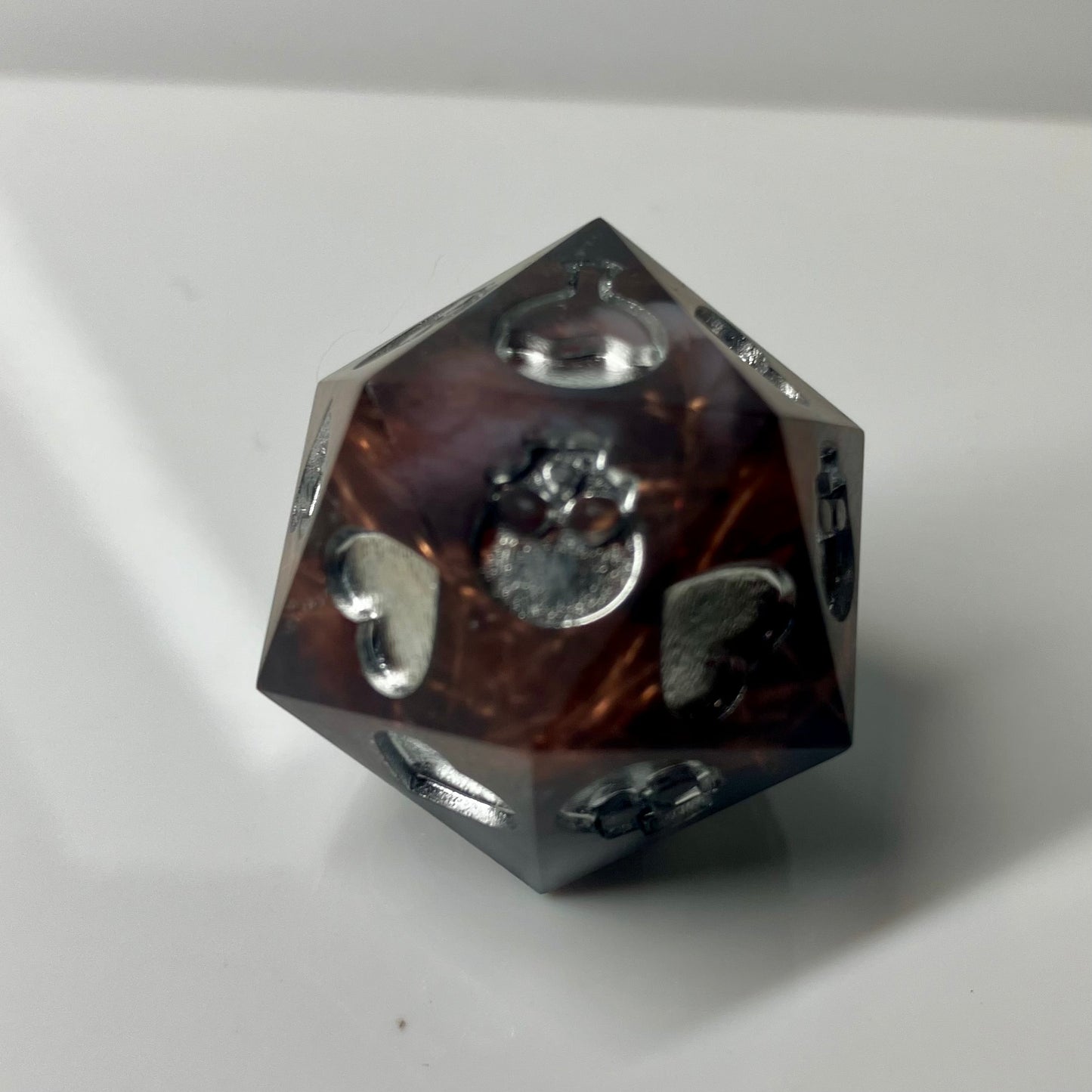 Copper, marble and silver come together in this hand made d20