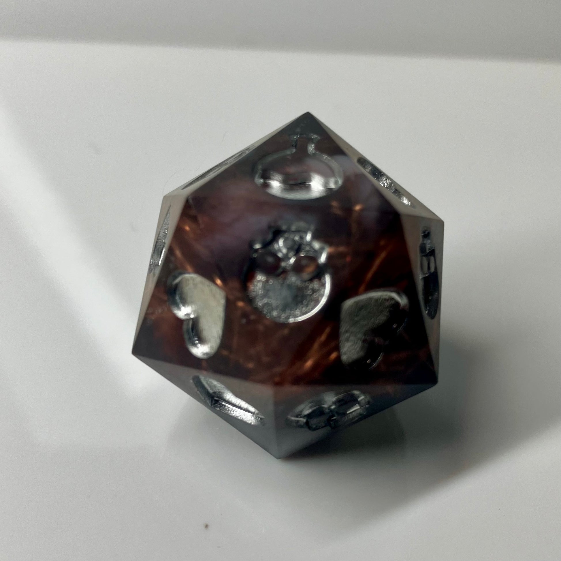 Copper, marble and silver come together in this hand made d20