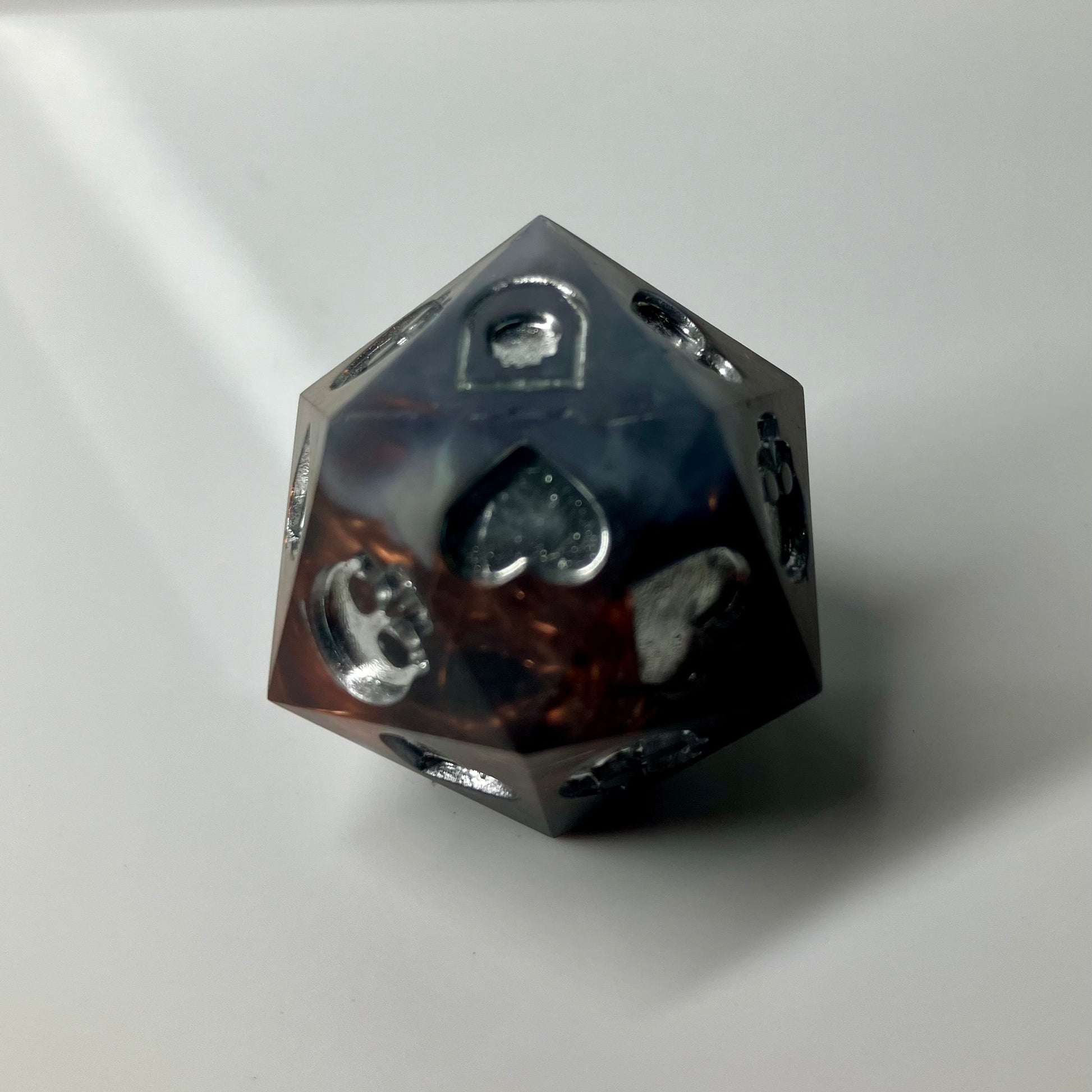 Copper, marble and silver come together in this hand made d20