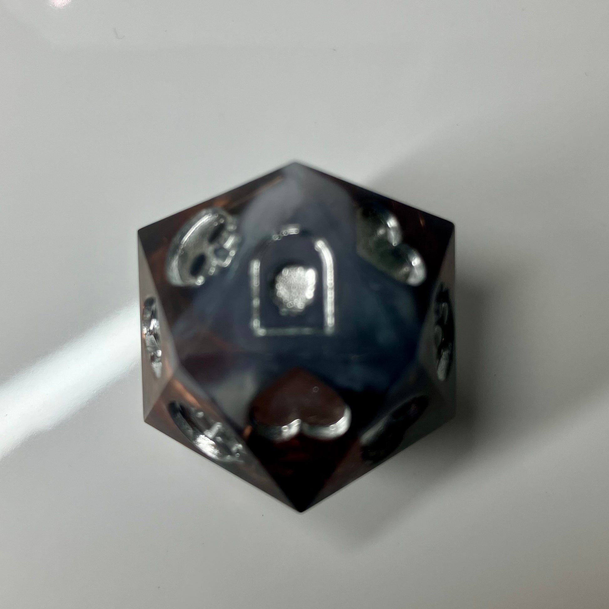 Copper, marble and silver come together in this hand made d20