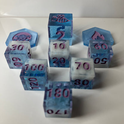 Sparkling clear blue dice with fluffy white clouds in them