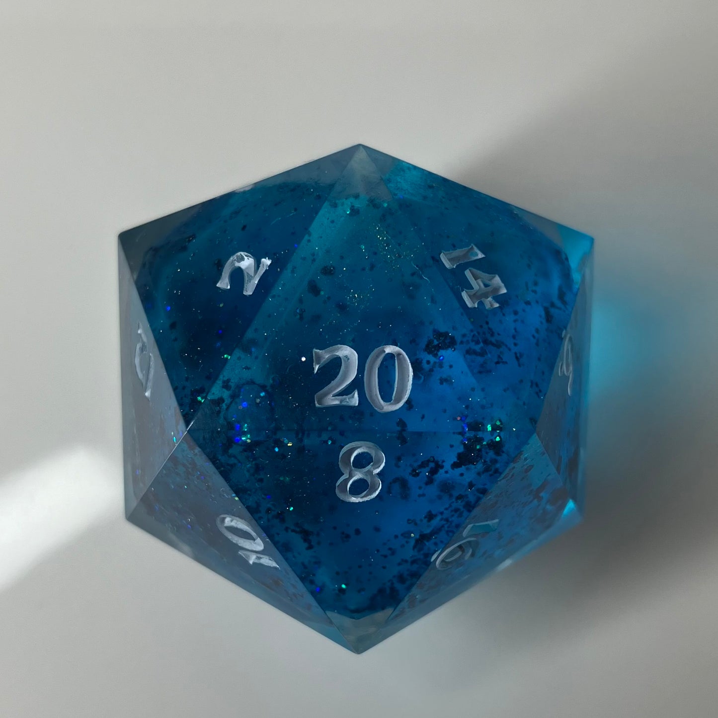 30mm d20 Chonk Liquid Core  blue d20 with floating glitter inside.
