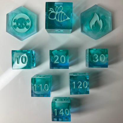 Sparkling teal dice with white clouds for use with the Pokemon TCG