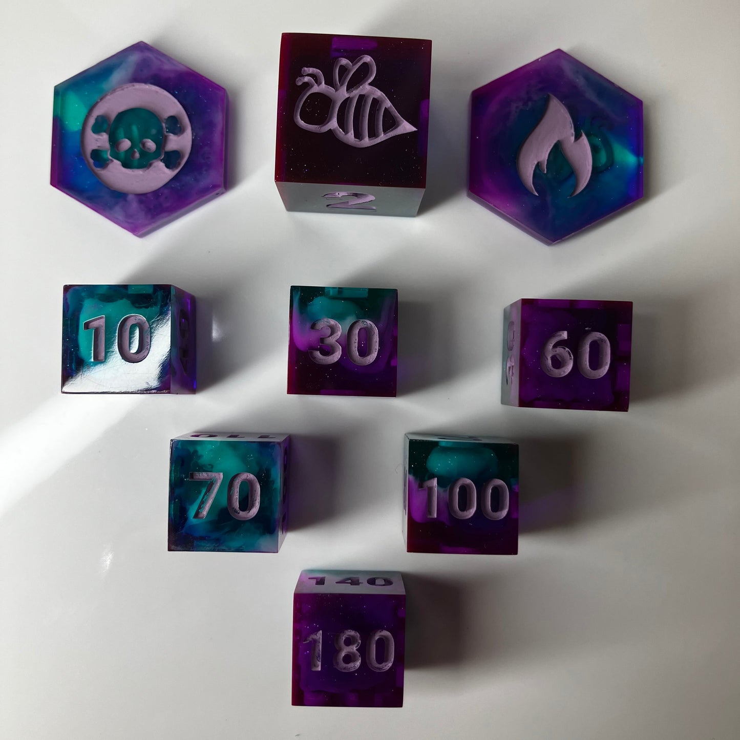 Set of purple dice with numbers and symbols for the Pokemon TCG