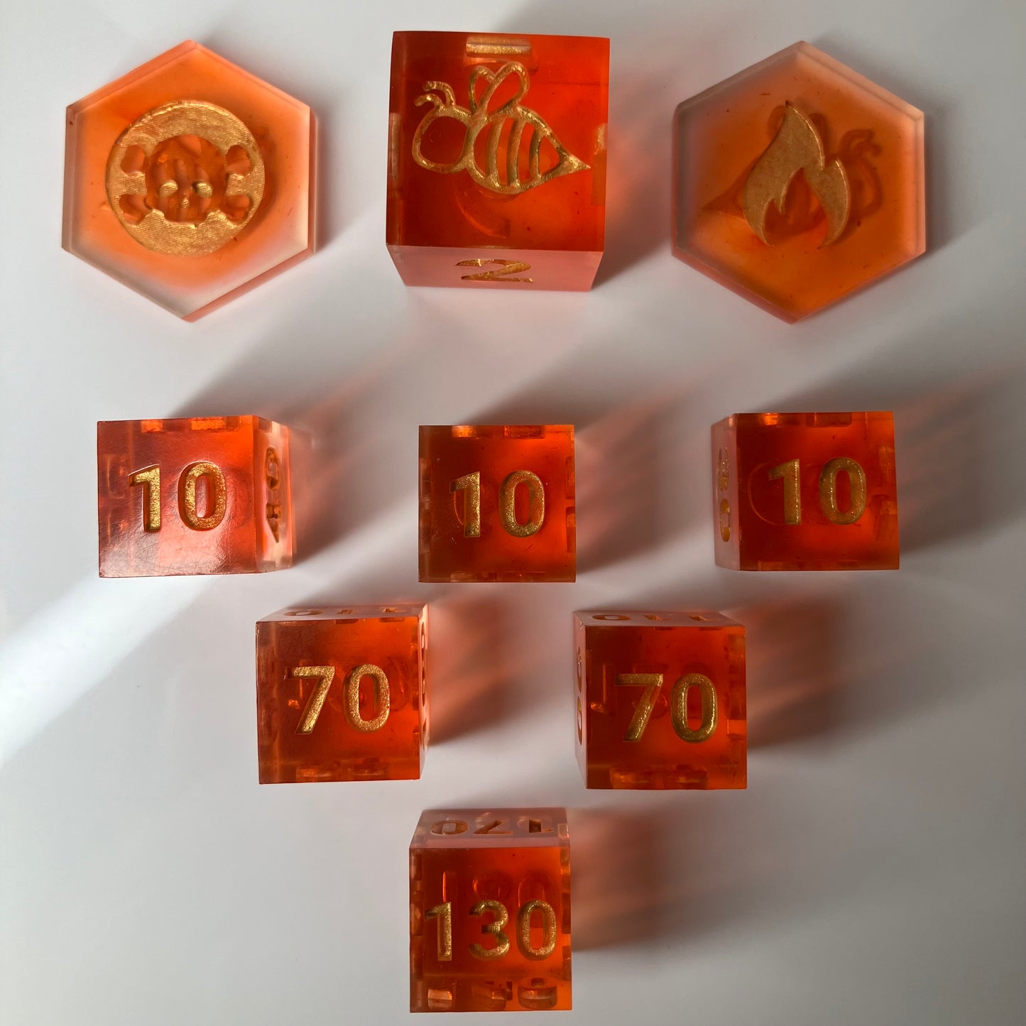 Set of orange dice with gold numbers for the Pokemon