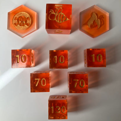 Set of orange dice with gold numbers for the Pokemon