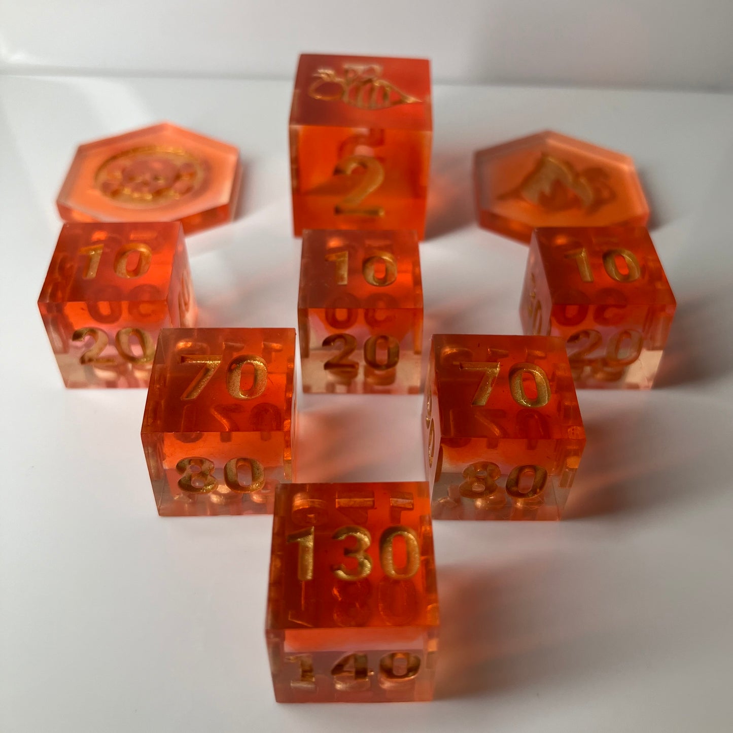 Set of orange dice with gold numbers for the Pokemon TCG
