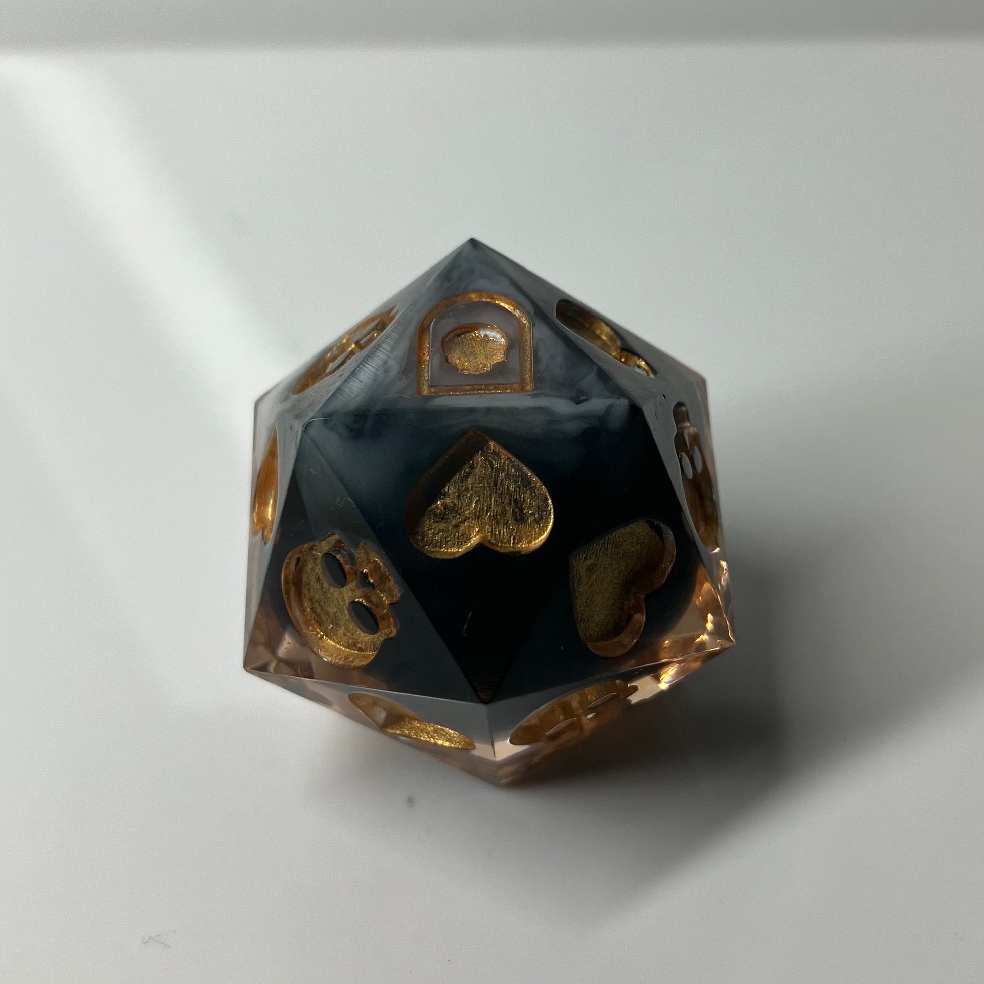 black and gold d20 for rolling death saves 