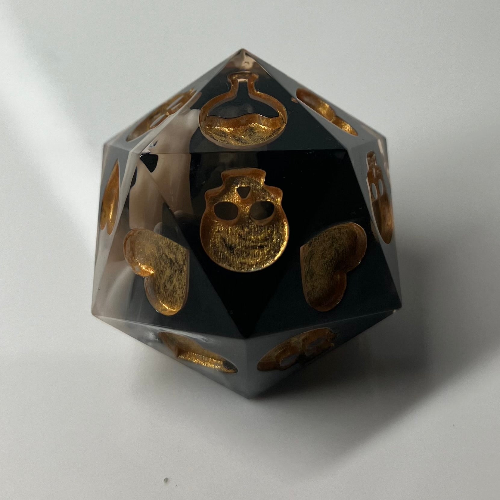 black and gold d20 for rolling death saves 