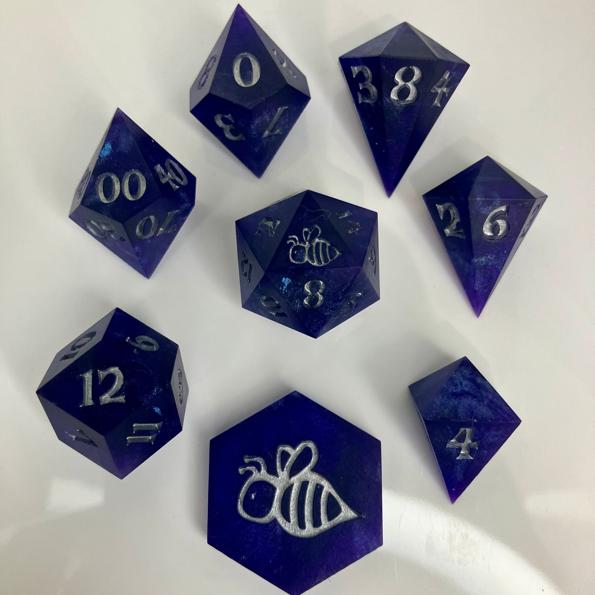 royal purple dice with numbers painted silver in gemstone shapes