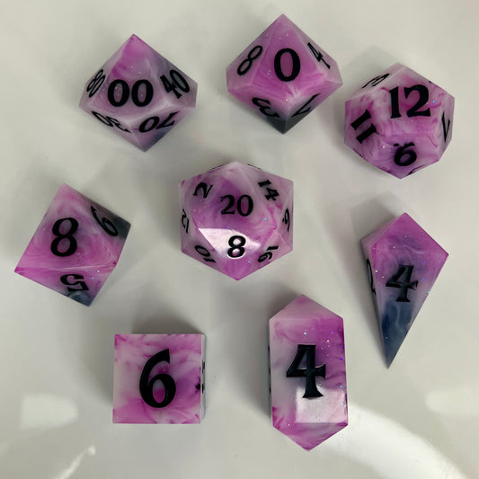 Polyhedral dice set that goes from smokey black to pink