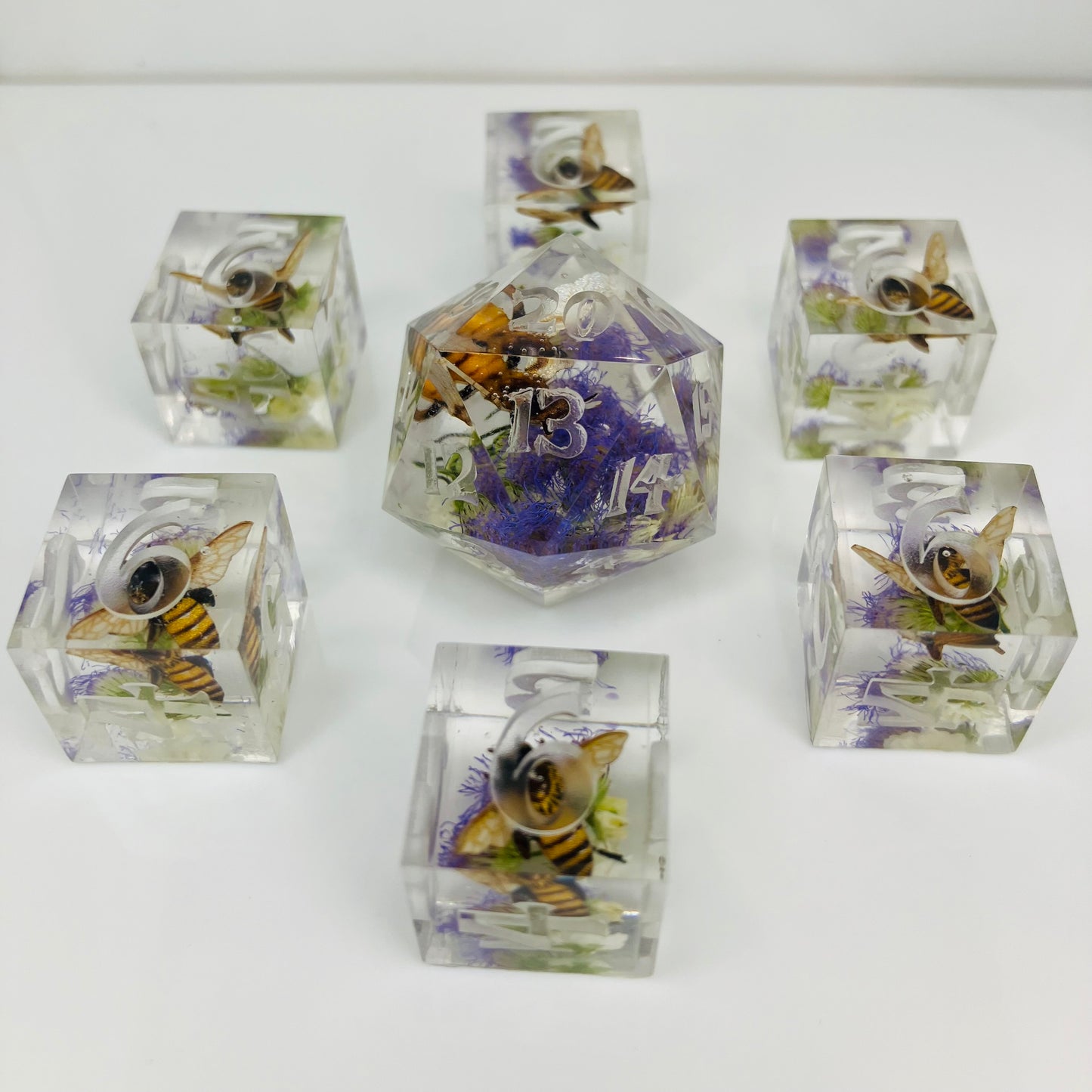 Set of clear dice with bee and flower designs for Lorcana