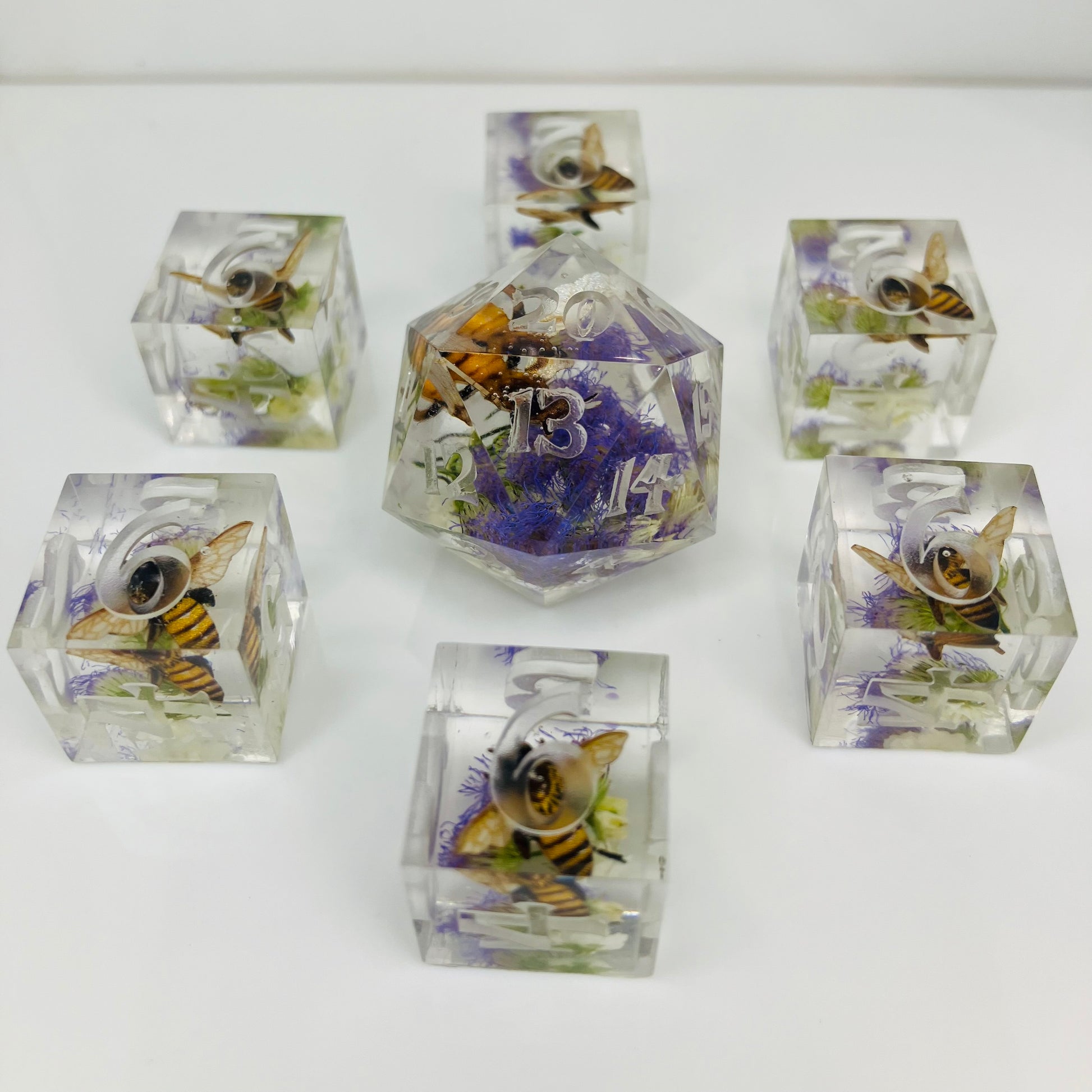 Set of clear dice with bee and flower designs for Lorcana