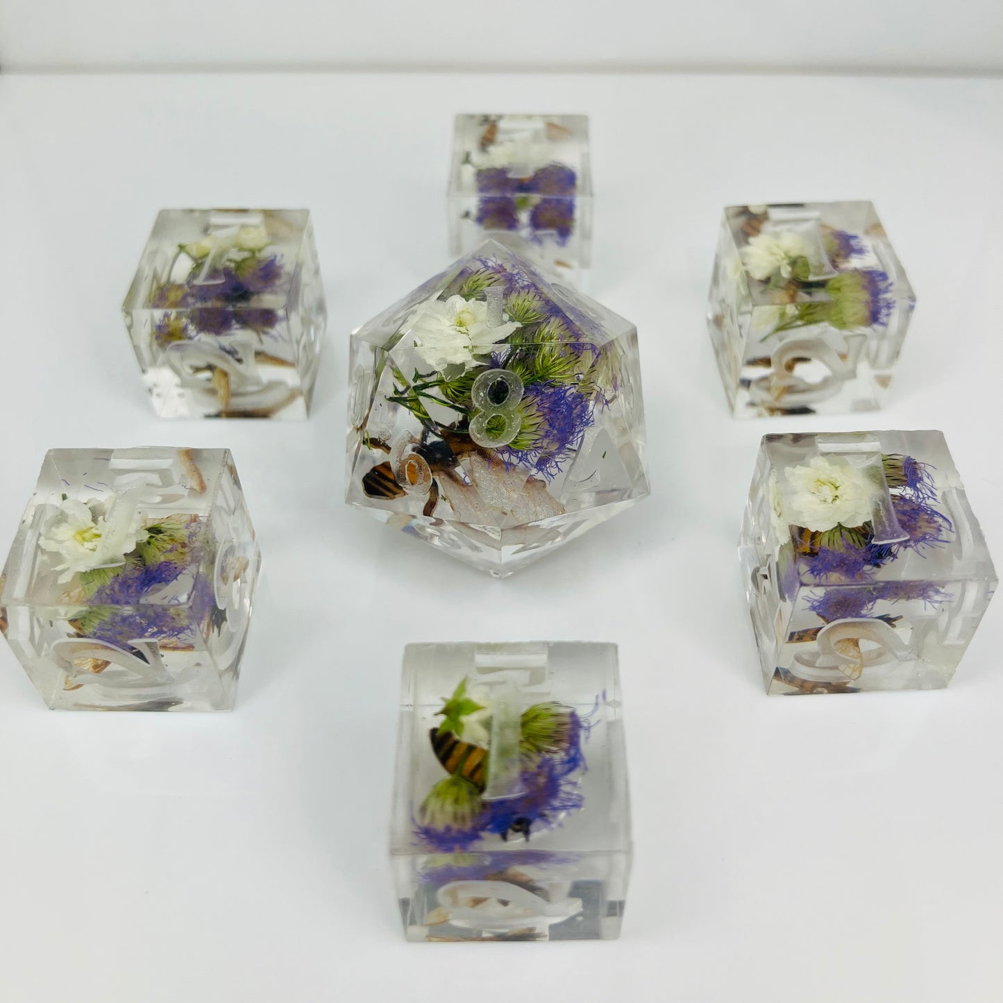 6 d6 and a d20 spindown with embedded flowers and bees made for lorana