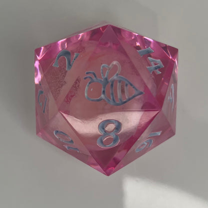 clear pink d20 with bee logo and 'moon' insert