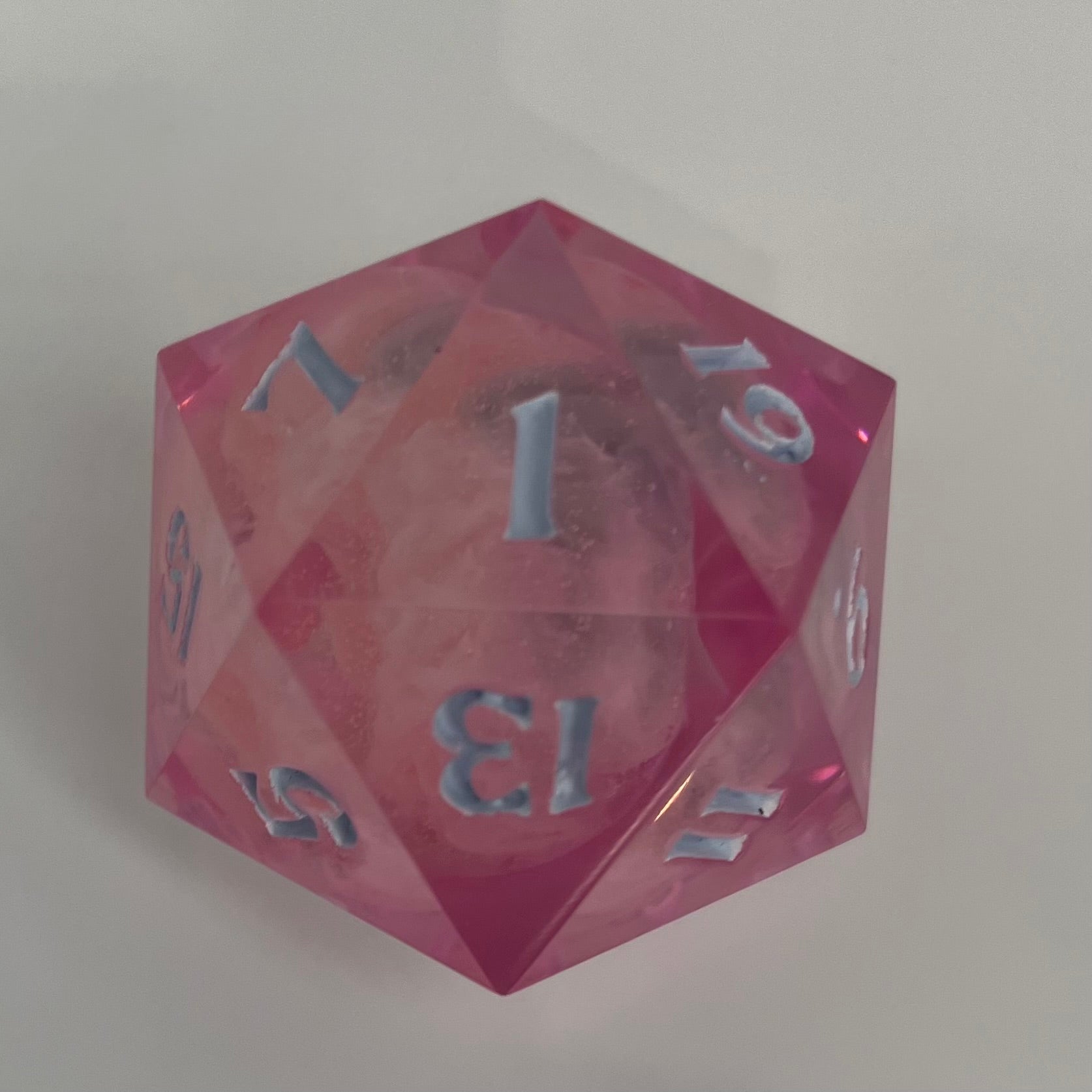 clear pink d20 with bee logo and 'moon' insert