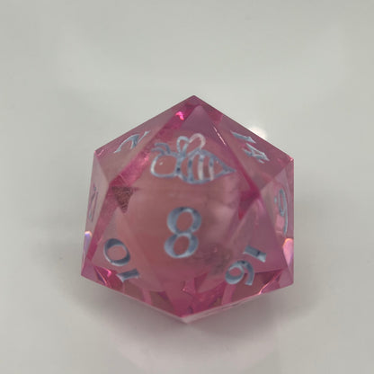clear pink d20 with bee logo and 'moon' insert