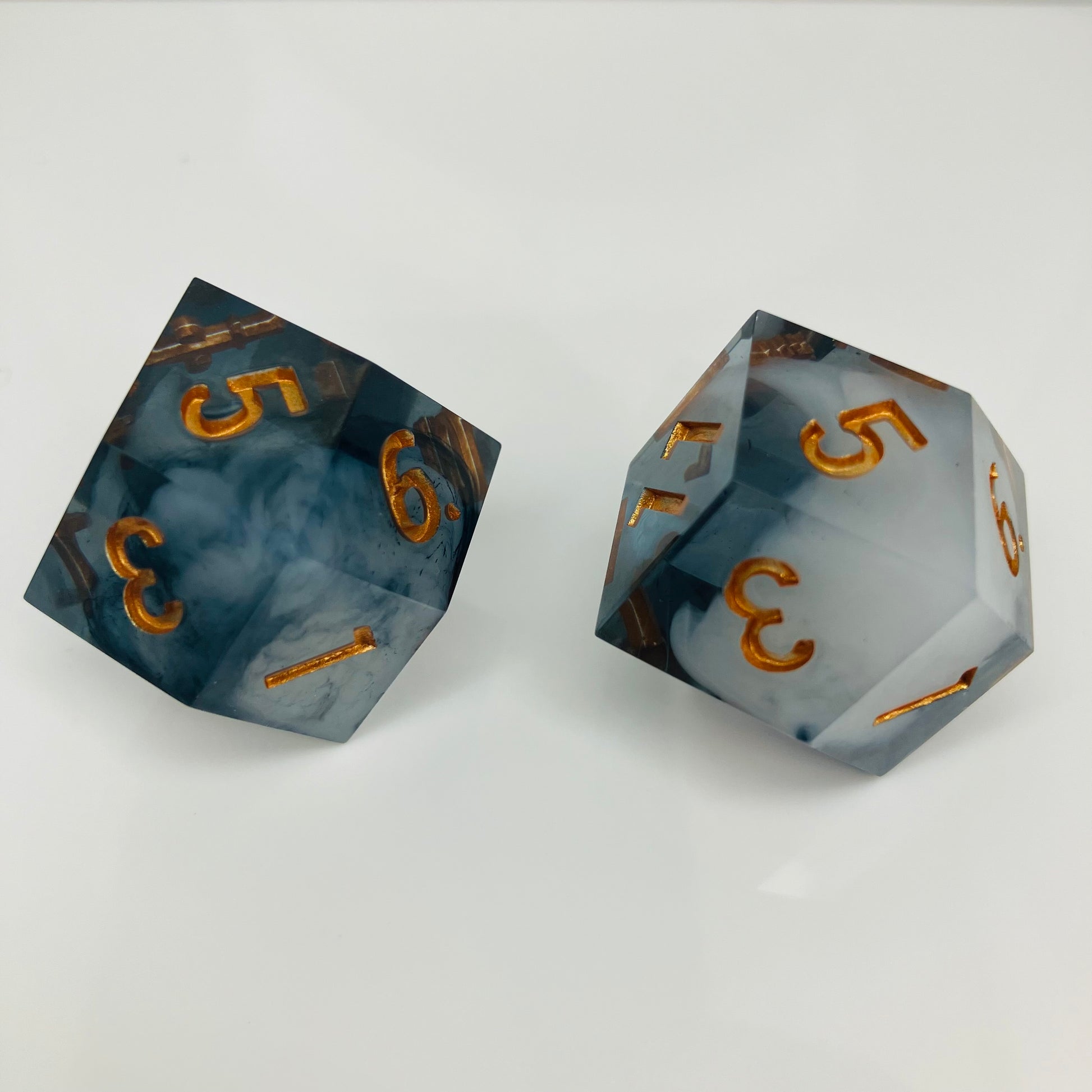 black and grey daggerheart dice with gold numbers