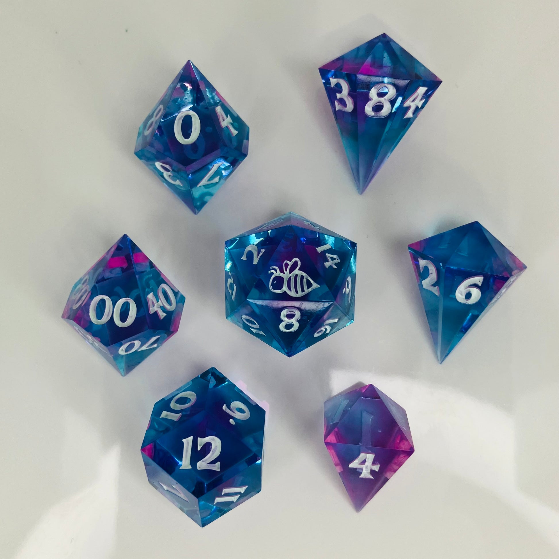 Set of 7 polyhedral dice in gemstone shapes.