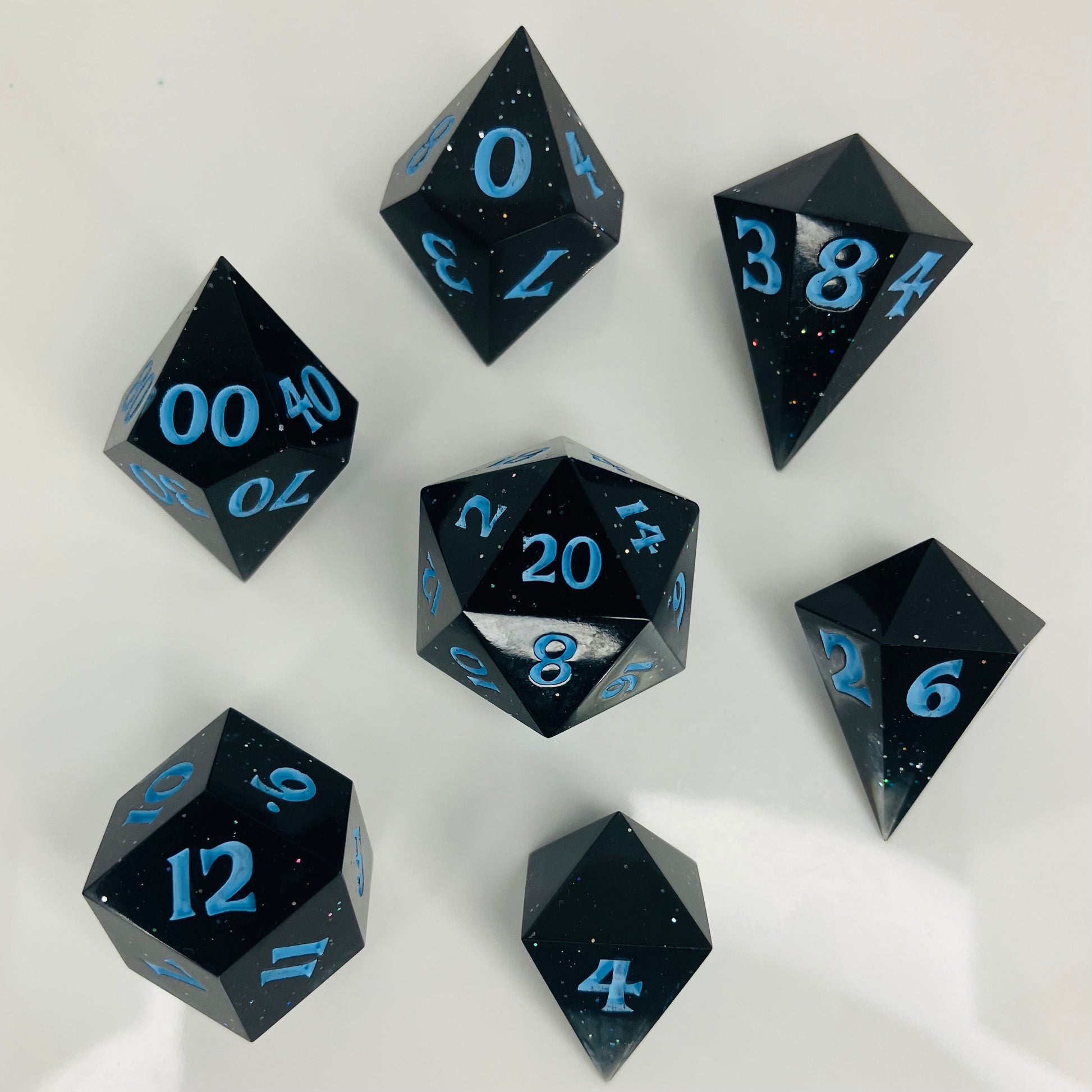 Clear to black gemstone set of gaming dice with sparkles.