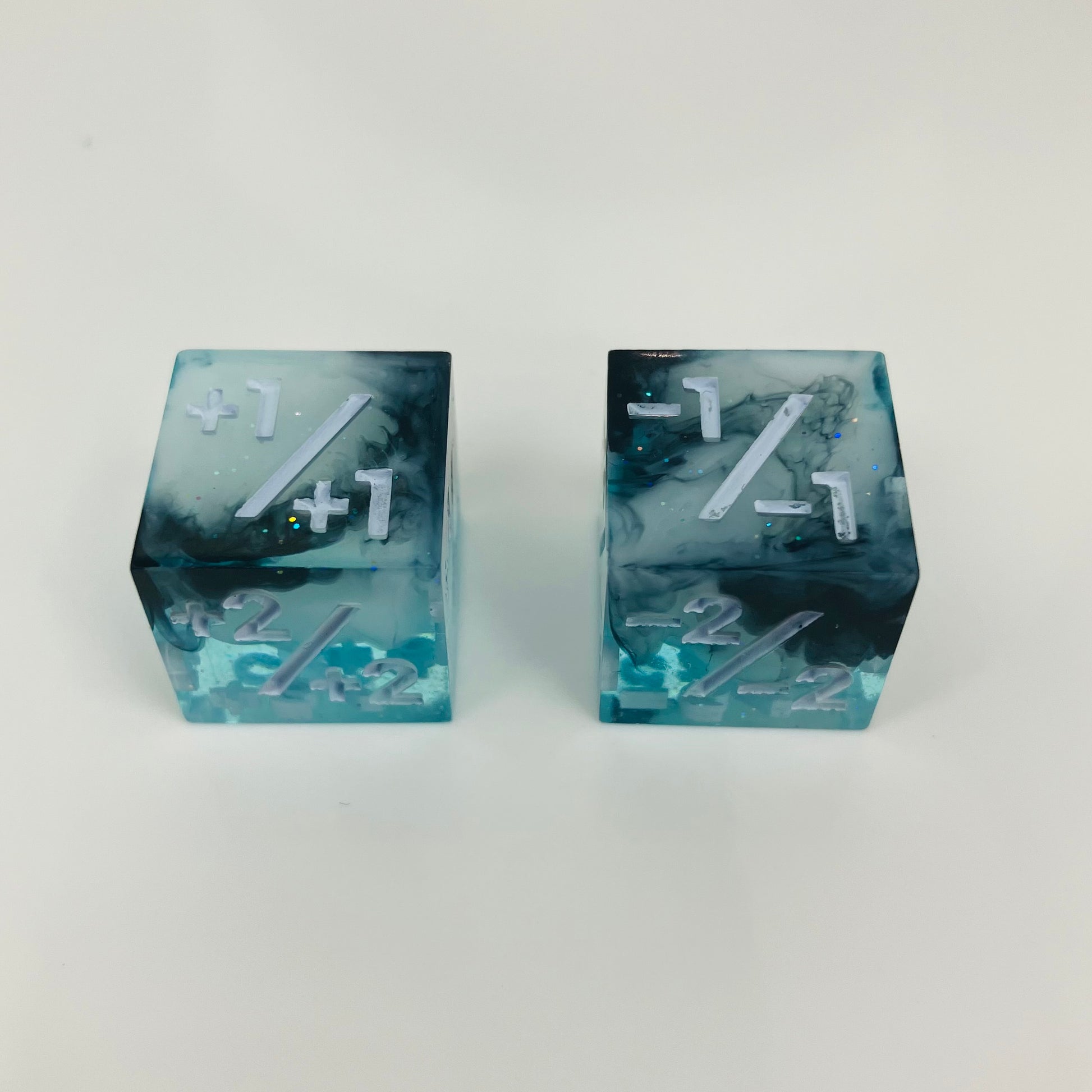 Two blue and black dice with white text on a white background