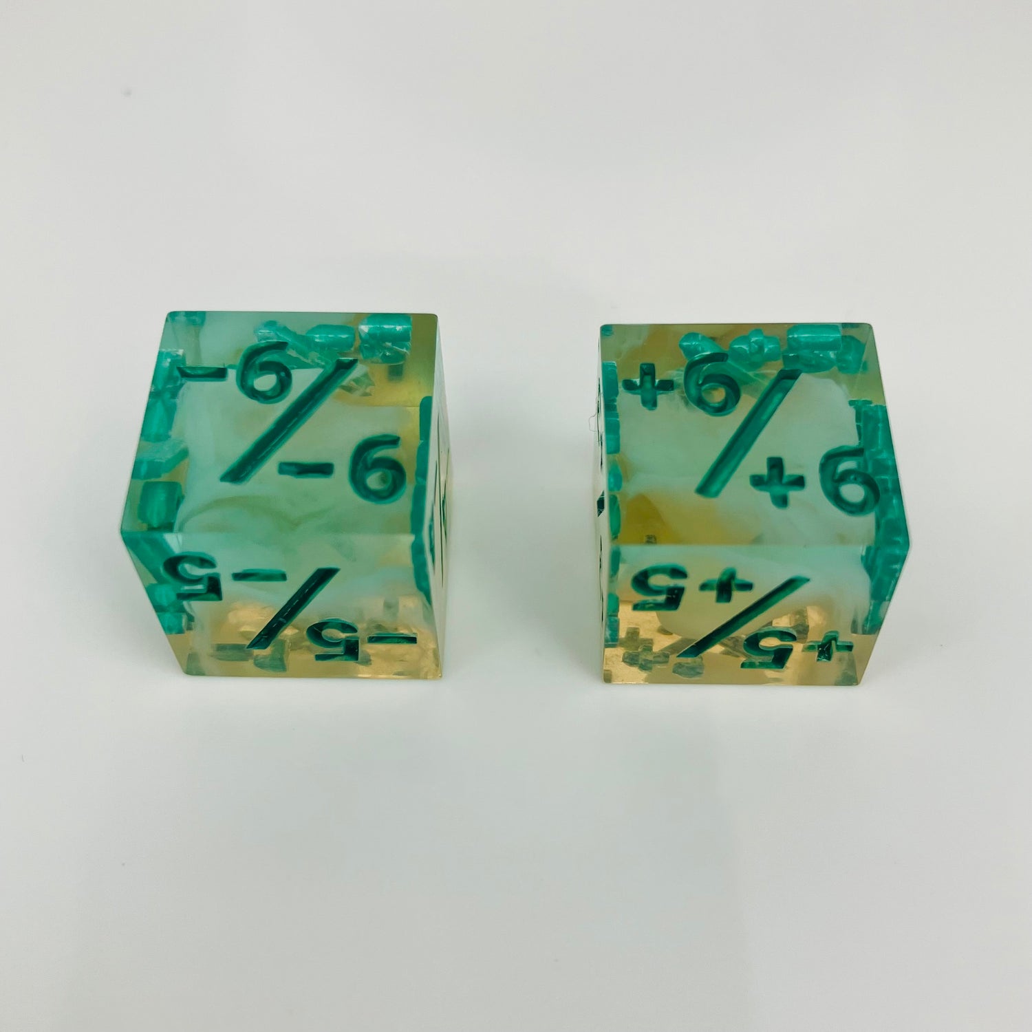 Green and yellow transparent dice with spore cloud inside.