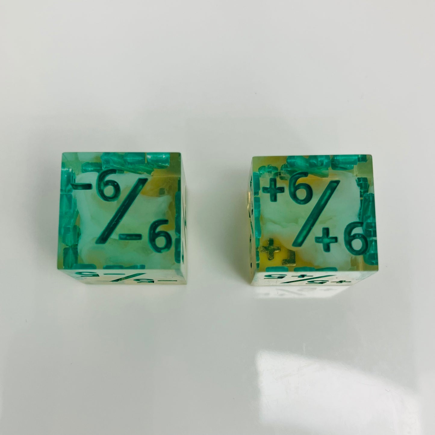 Green and yellow transparent dice with spore cloud inside.