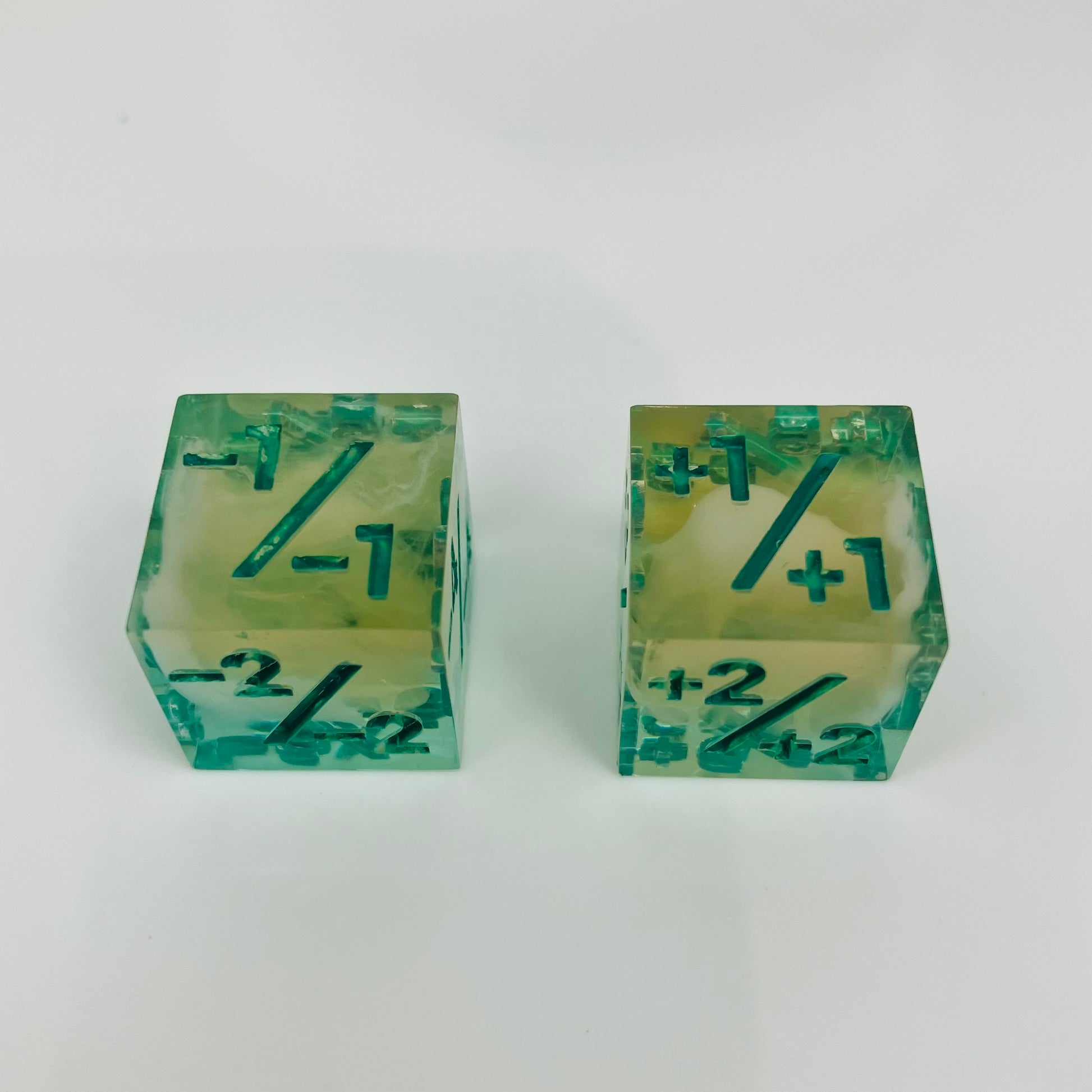 Green and yellow transparent dice with spore cloud inside.