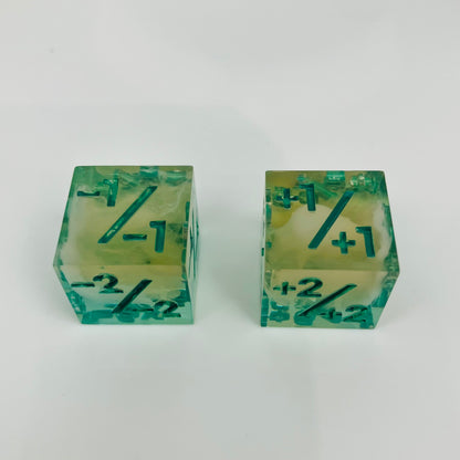 Green and yellow transparent dice with spore cloud inside.
