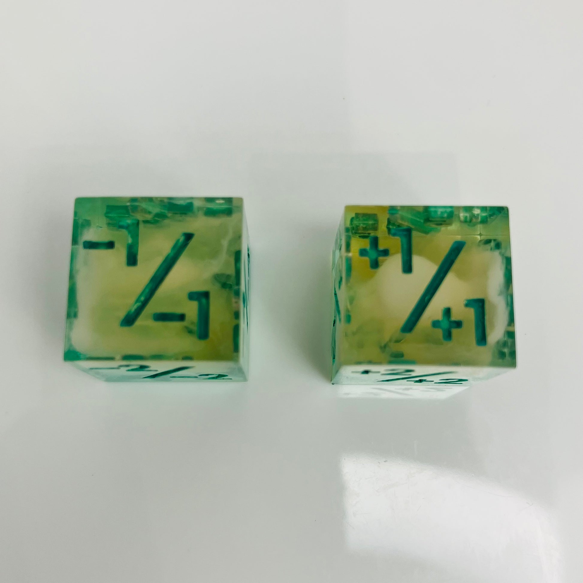 Green and yellow transparent dice with spore cloud inside.