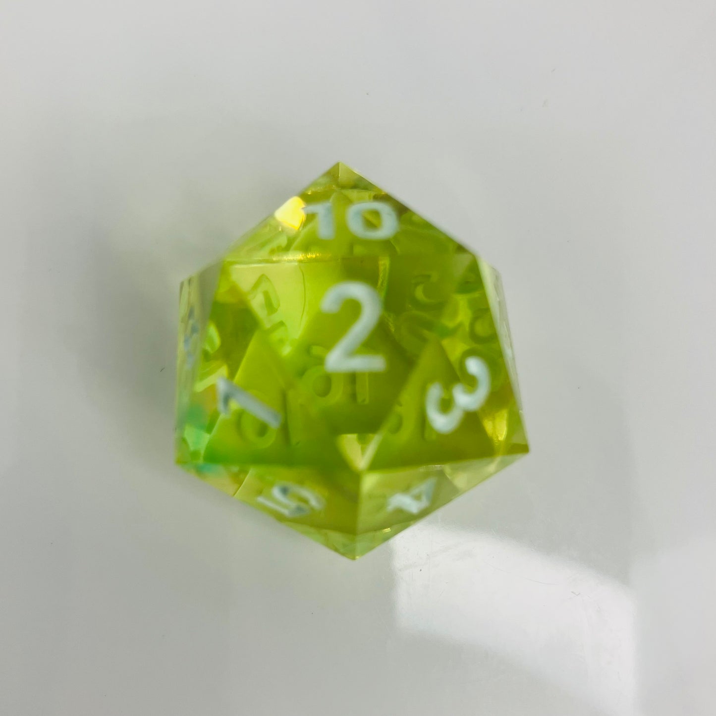 Bright and clear green and yellow spindown d20 with white numbers