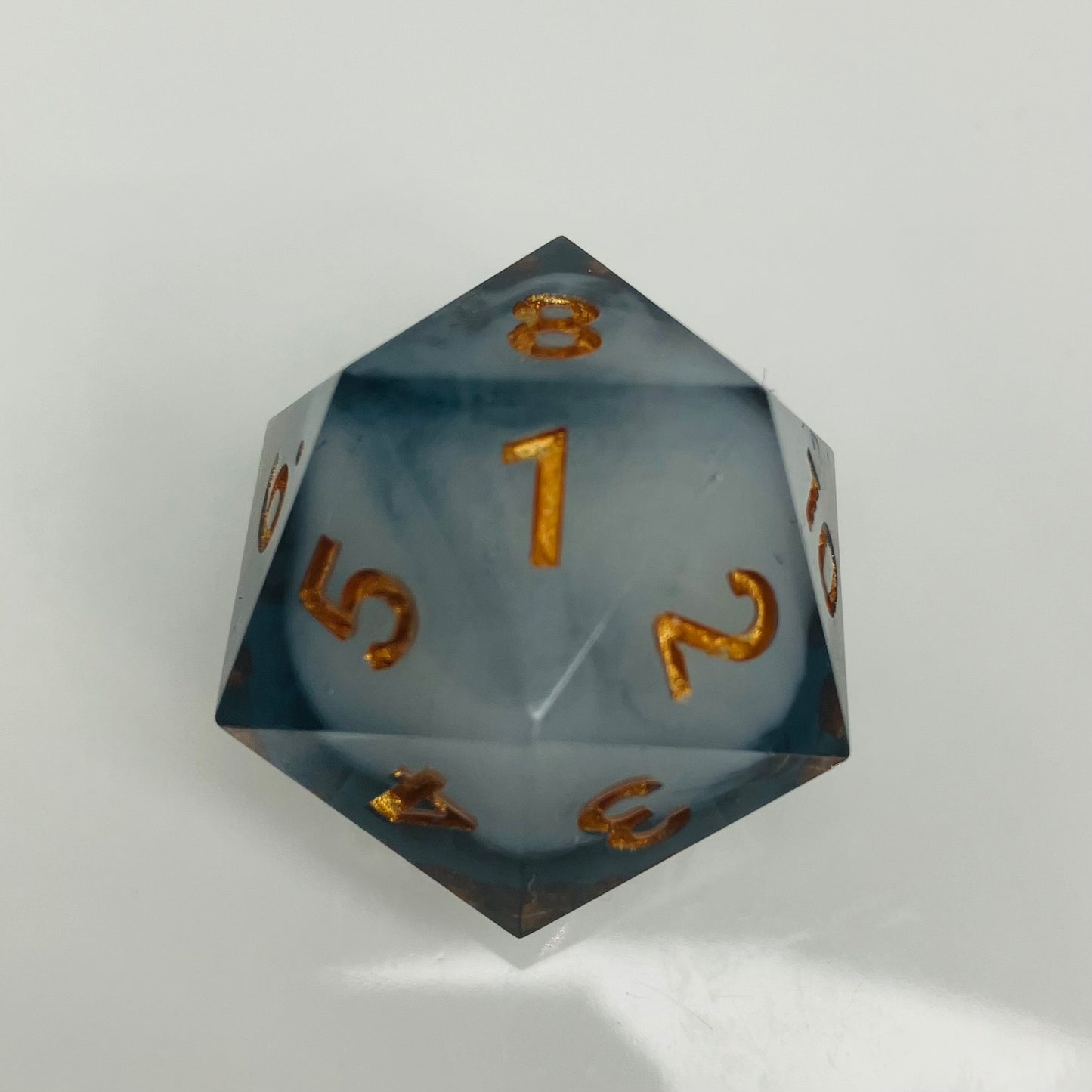 White cloud in dark grey spindown d20 with gold numbers