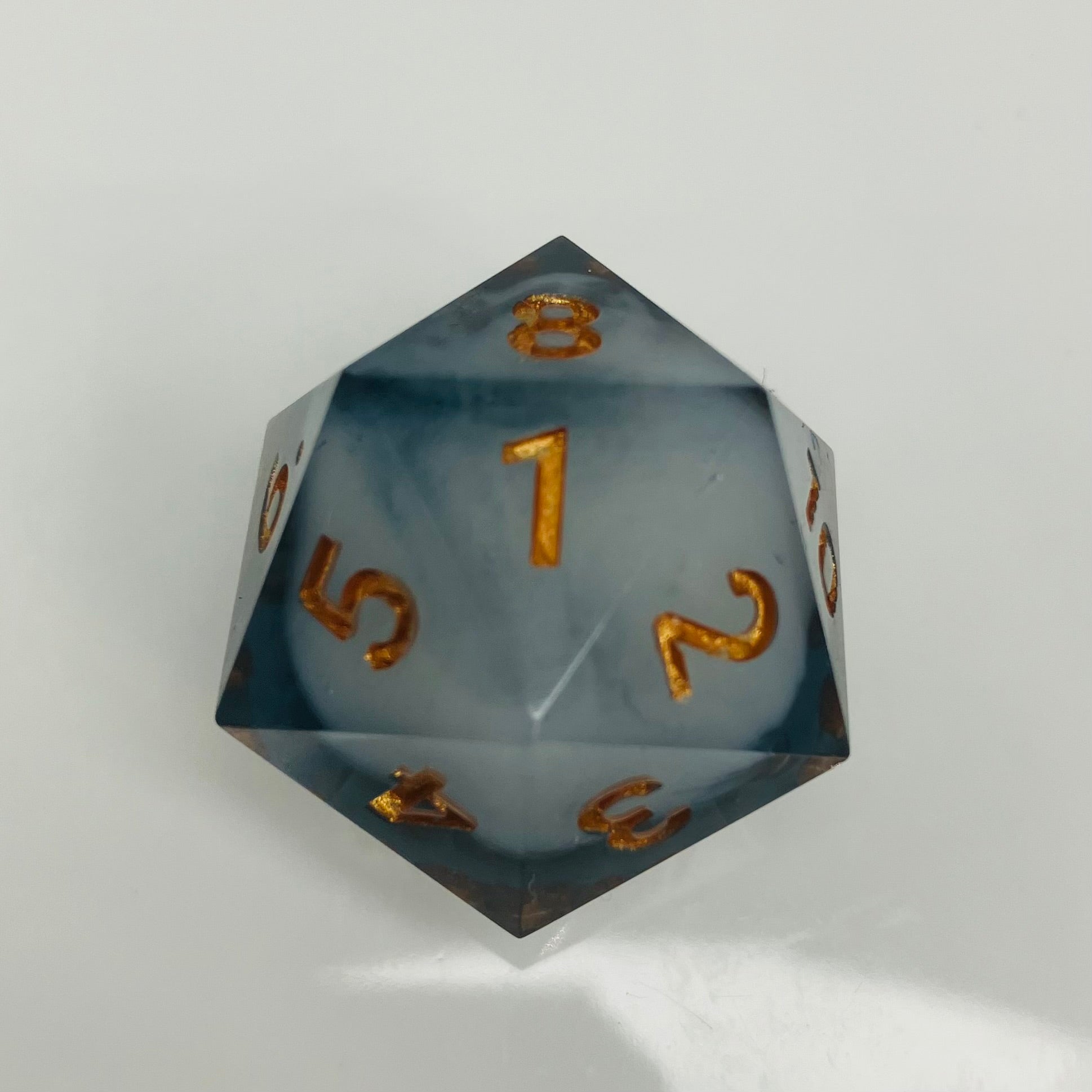 White cloud in dark grey spindown d20 with gold numbers