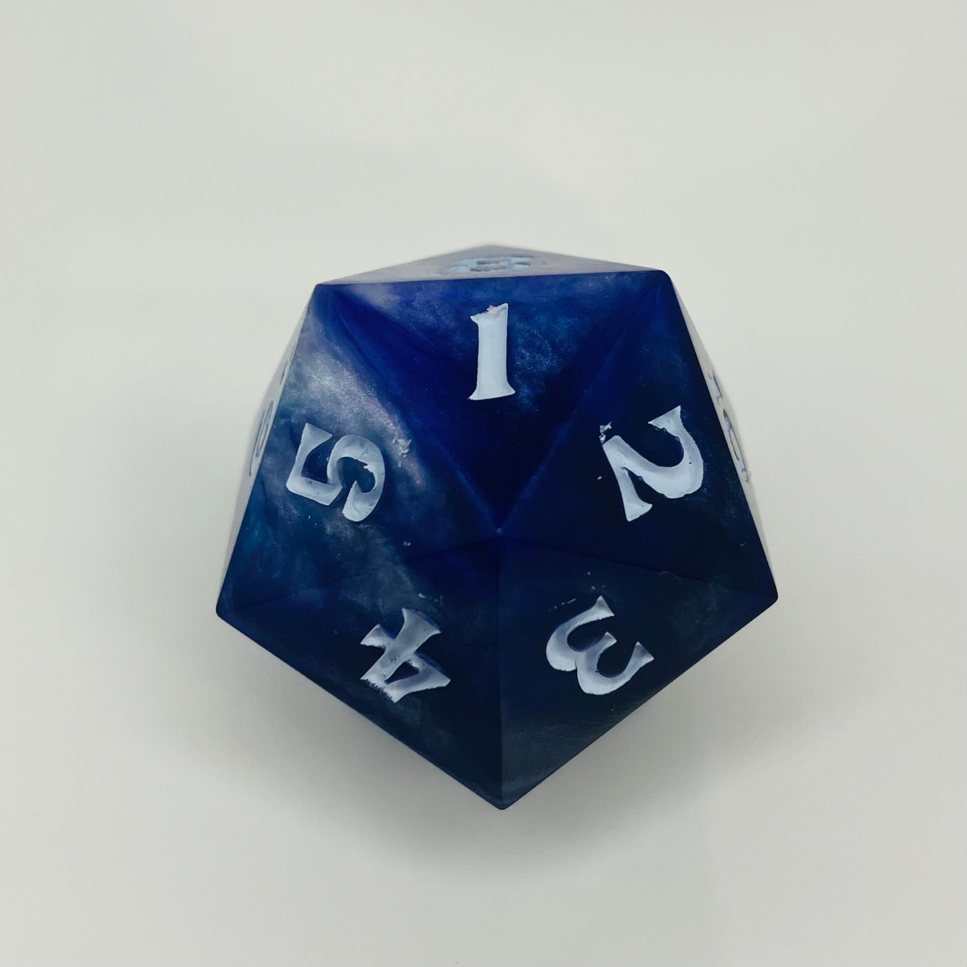 indigo and blue with silver swirls cast in a spindown d20
