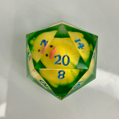 Yellow ducky laying on hand painted grass in a d20 chonk